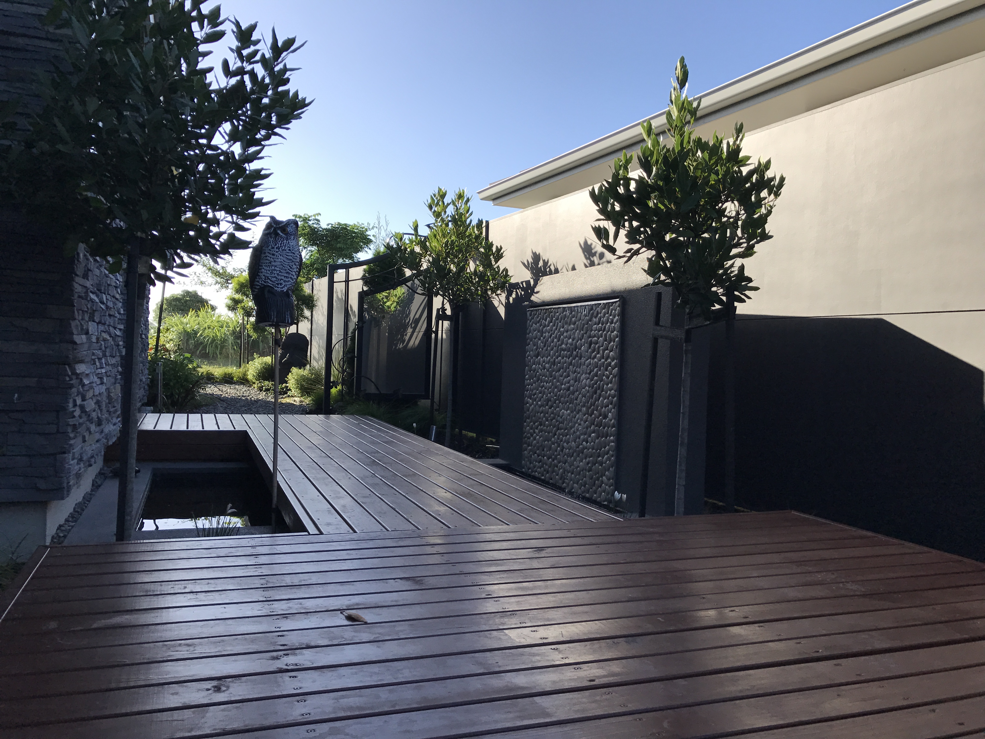 Front entrance way, water feature, decking board walk with formal planting